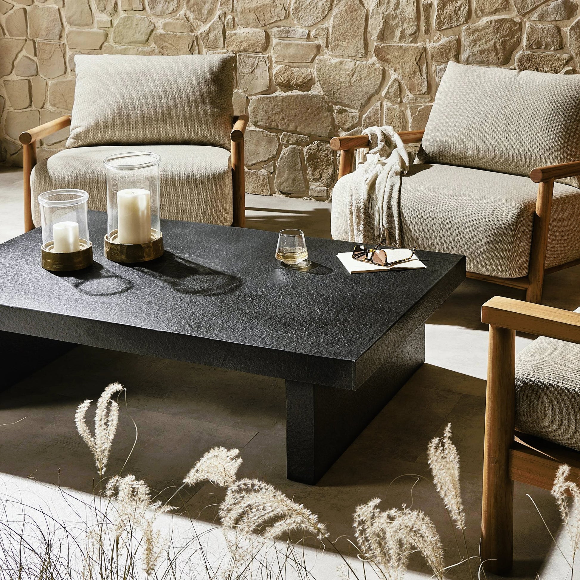 Huesca Outdoor Coffee Table by Four Hands in distressed graphite concrete. Made from concrete in a modern style.