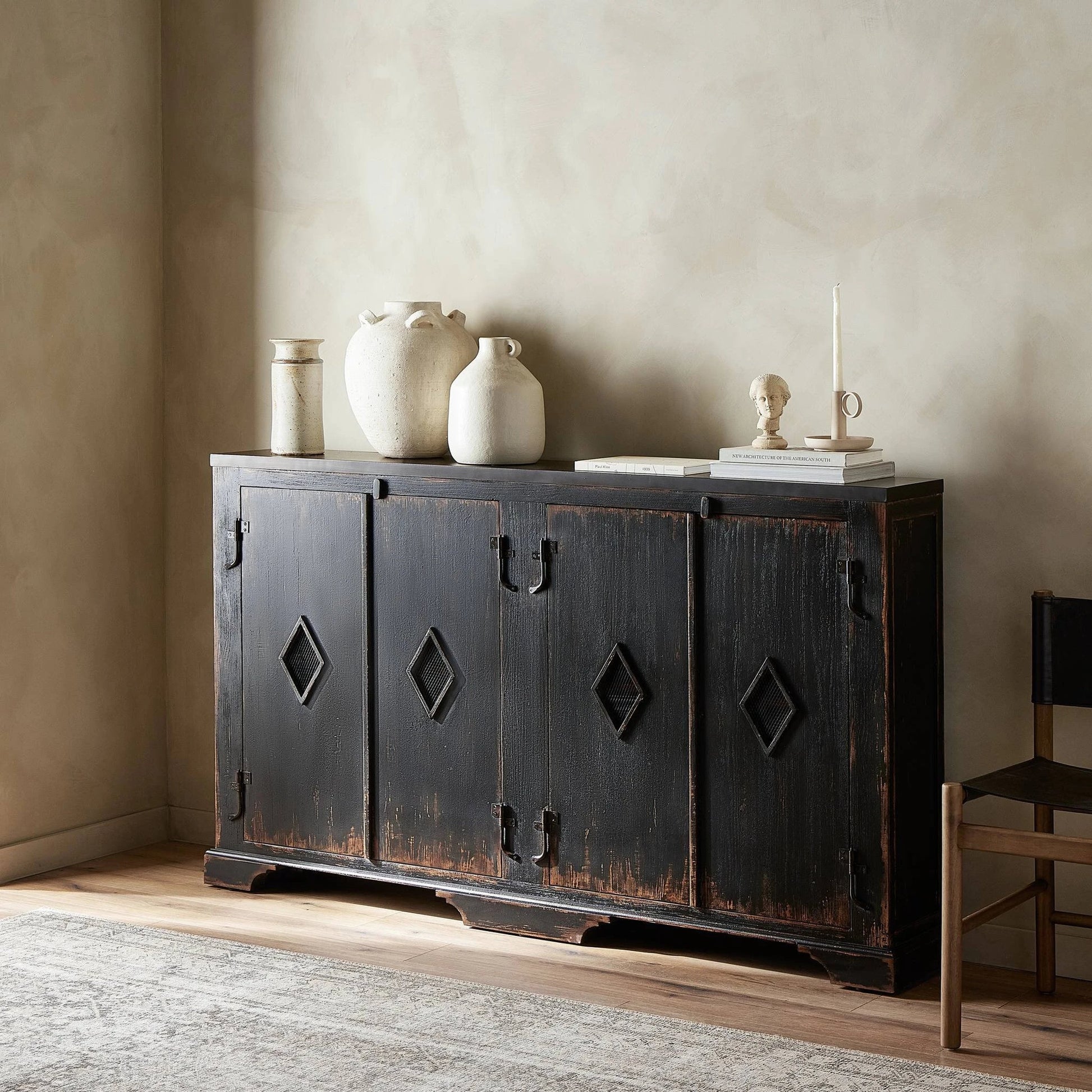 The Humptulips River Moonshine Cabinet by Four Hands in distressed burnt black. Made from pine veneer, solid pine in a modern style.