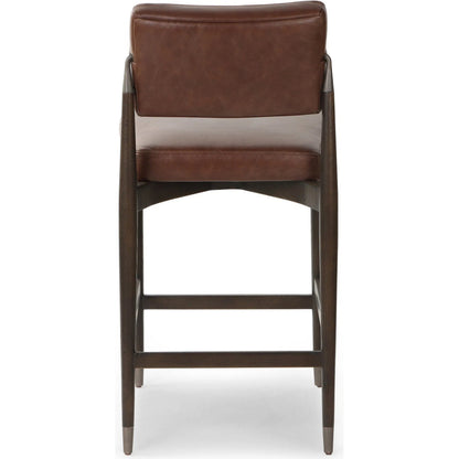 Anton Counter Stool by Four Hands in havana brown, burnt oak, raw iron. Made from top grain leather, solid oak, iron in a modern style.