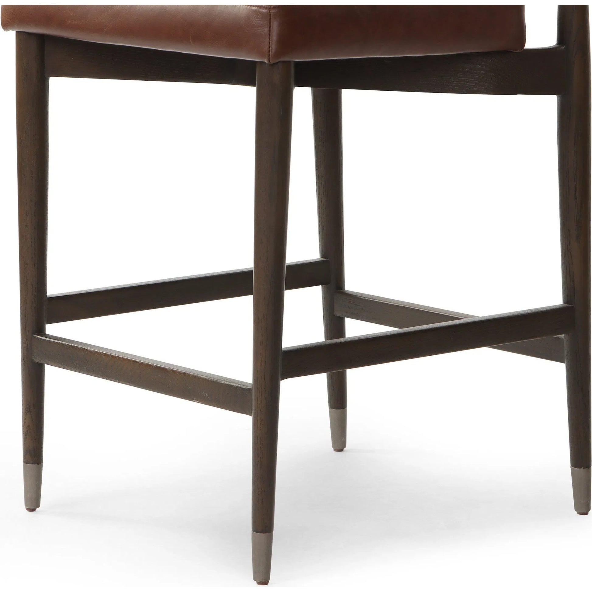 Anton Counter Stool by Four Hands in havana brown, burnt oak, raw iron. Made from top grain leather, solid oak, iron in a modern style.