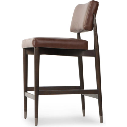 Anton Counter Stool by Four Hands in havana brown, burnt oak, raw iron. Made from top grain leather, solid oak, iron in a modern style.