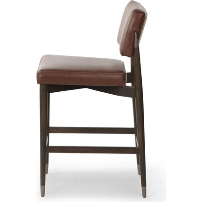 Anton Counter Stool by Four Hands in havana brown, burnt oak, raw iron. Made from top grain leather, solid oak, iron in a modern style.