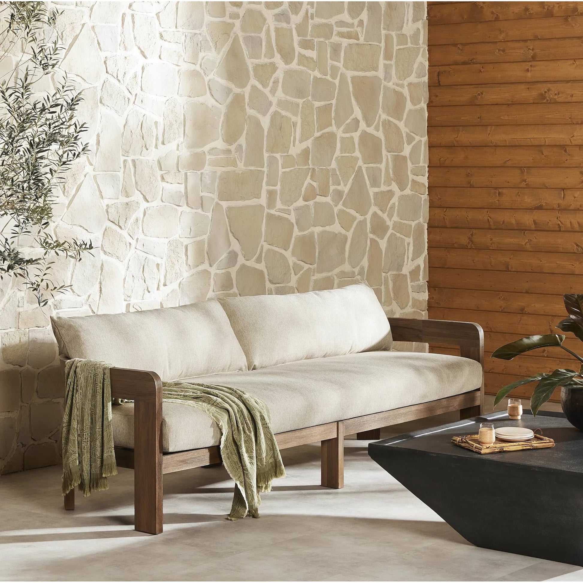 Jackson Outdoor Sofa by Four Hands. Made from 100% olefin, solid fsc®-certified teak, 91% polyurethane foam pad, 9% polyester fiber batting in a modern style.
