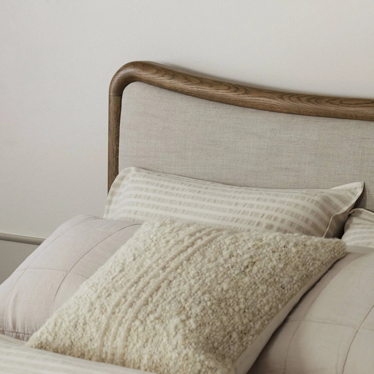 011 SI-2519154 | Closeup | Dover Bed by Four Hands in hockney linen, rustic amber oak veneer. Made from 86% polyester, 14% flax/linen, thick oak veneer, solid oak in a transitional style.