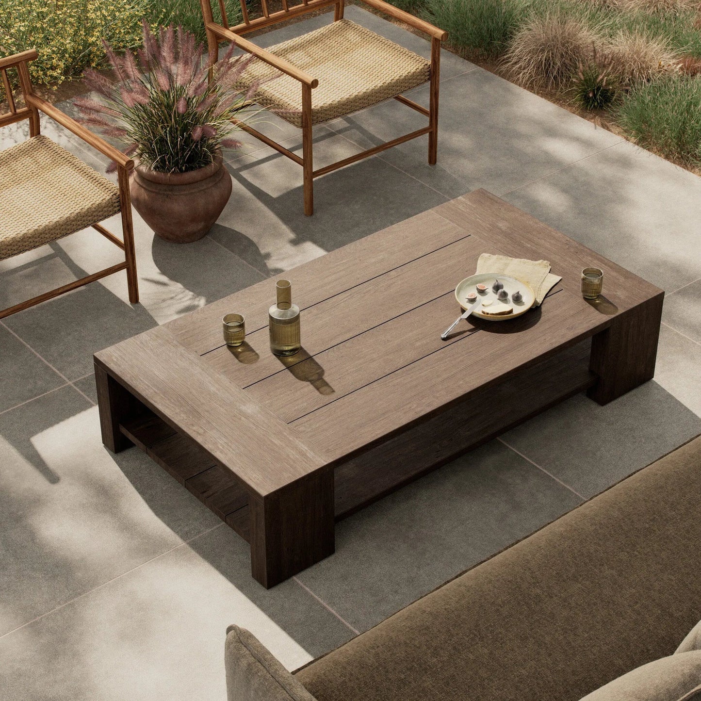 015 SI-2257151 | Lifestyle | Roca Outdoor Coffee Table by Four Hands in stained heritage brown-fsc. Made from solid fsc® reclaimed teak in a transitional style.