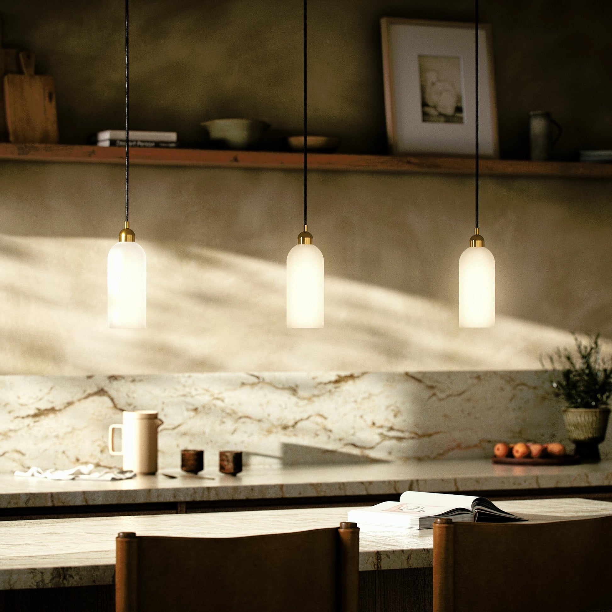 Odyssey Single Pendant by Four Hands in opal matte glass, black cord, burnished brass and opal matte glass. Made from glass, thermoplastic, brass in a modern style.