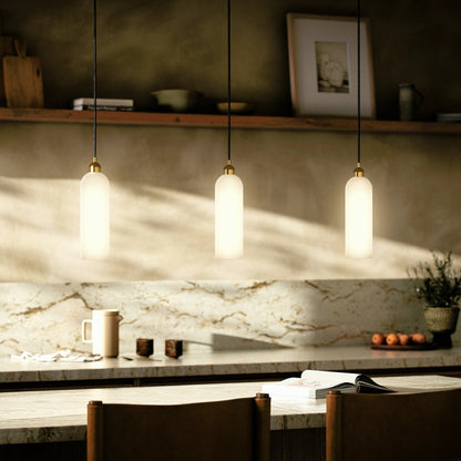 Odyssey Single Pendant by Four Hands in opal matte glass, black cord, burnished brass and opal matte glass. Made from glass, thermoplastic, brass in a modern style.