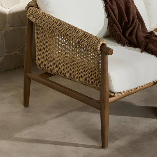 Cambrie Outdoor Sofa by Four Hands in arashi salt, stained toasted brown, faux hyacinth. Made from 100% acrylic, solid teak, 100% polyethylene in a rustic style.