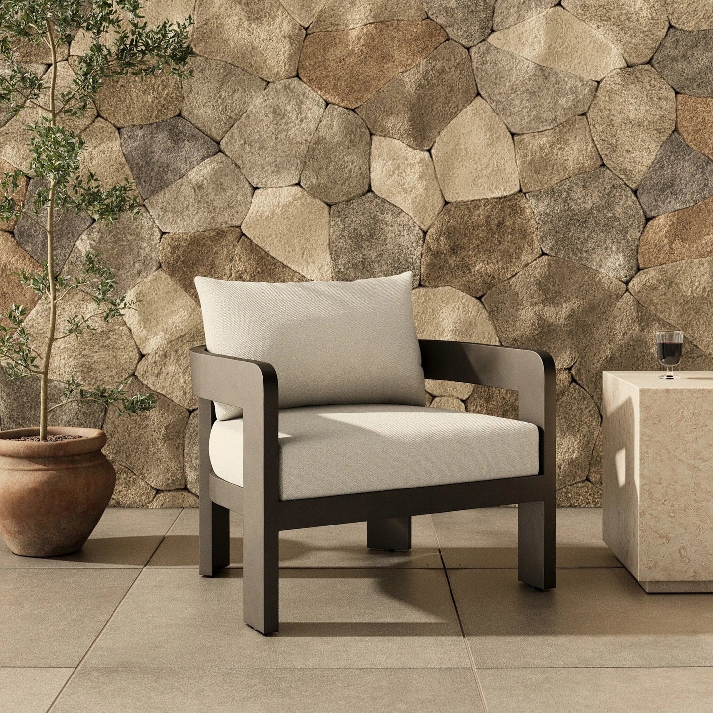 015 SI-2257158 | Lifestyle | Jackson Outdoor Metal Chair by Four Hands in alessi linen, bronze. Made from 100% polypropylene, aluminum, 91% polyurethane foam pad, 9% polyester fiber batting in a modern style.