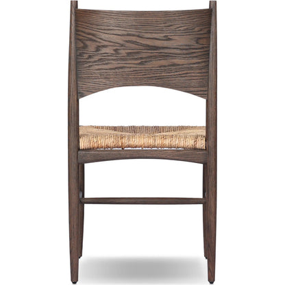 Jovan Dining Chair by Four Hands in stained saddle brown, slight dark bleaching. Made from solid oak, banana leaf in a traditional style.