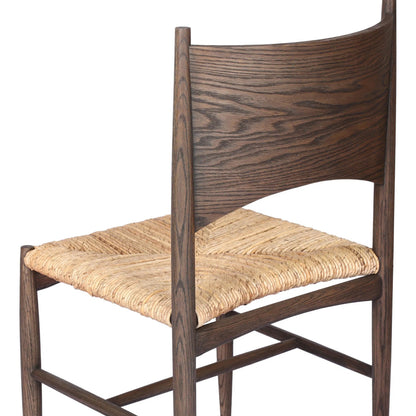 Jovan Dining Chair by Four Hands in stained saddle brown, slight dark bleaching. Made from solid oak, banana leaf in a traditional style.