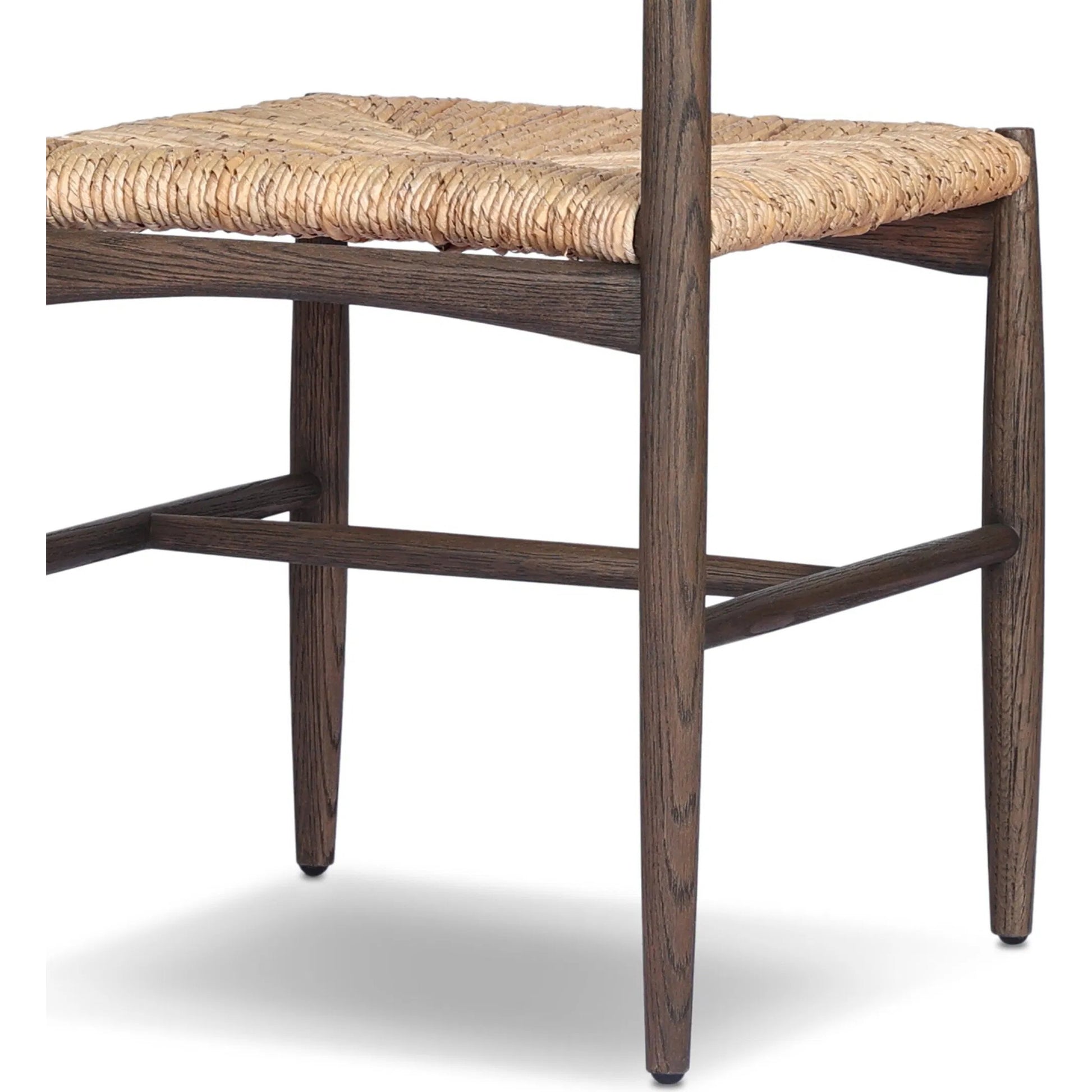 Jovan Dining Chair by Four Hands in stained saddle brown, slight dark bleaching. Made from solid oak, banana leaf in a traditional style.