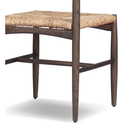 Jovan Dining Chair by Four Hands in stained saddle brown, slight dark bleaching. Made from solid oak, banana leaf in a traditional style.