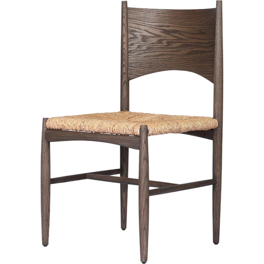 Jovan Dining Chair by Four Hands in stained saddle brown, slight dark bleaching. Made from solid oak, banana leaf in a traditional style.