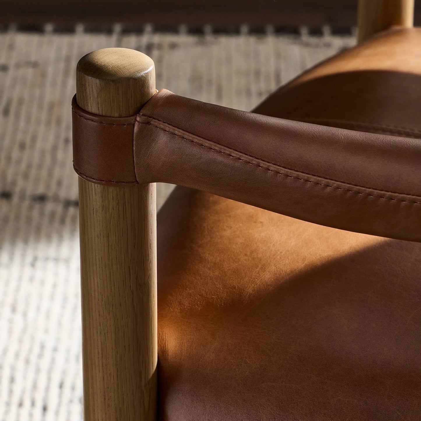 005 SI-2327535 | Closeup | Adaline Dining Armchair by Four Hands in sonoma chestnut, natural oak. Made from top grain leather, solid oak in a transitional style.