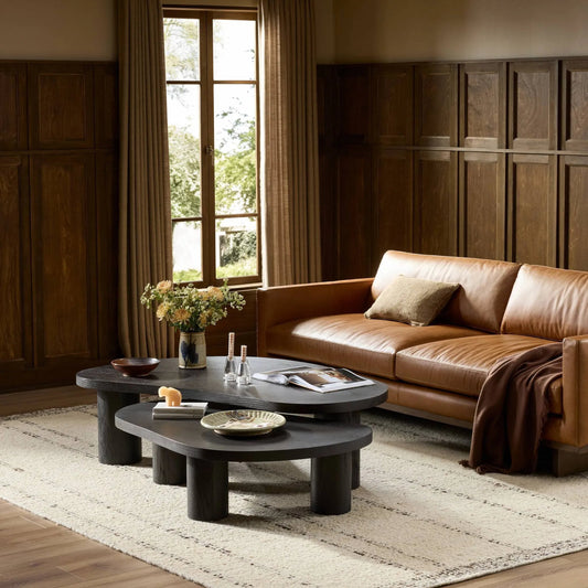 Joji Nesting Coffee Tables by Four Hands in aged black, aged black oak solid, aged black maple veneer. Made from thick oak veneer, solid oak, light maple veneer in a transitional style.