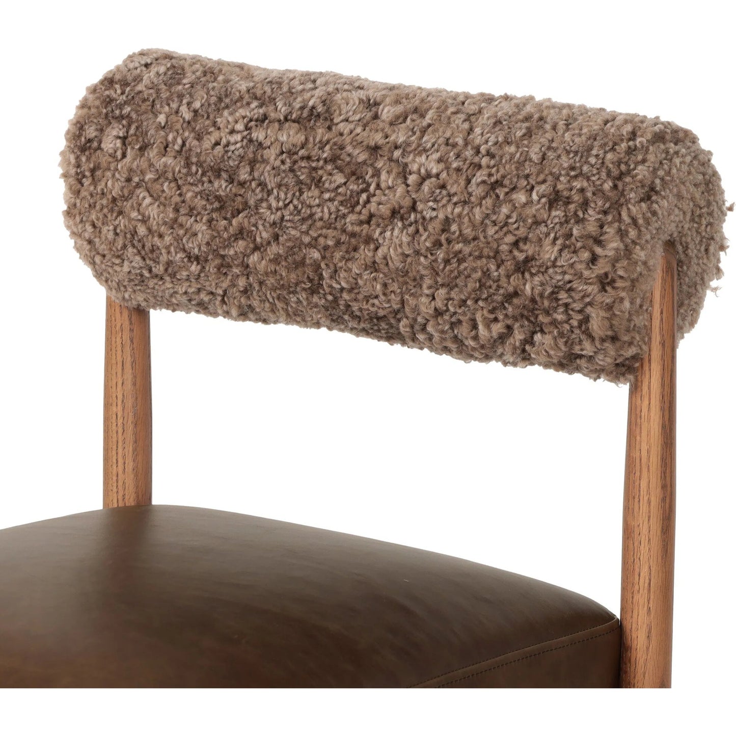 007 SI-2327565 | Closeup | Jazelle Dining Chair by Four Hands in havana brown, tan oak, taupe shearling. Made from top grain leather, solid oak, shearling in a traditional style.