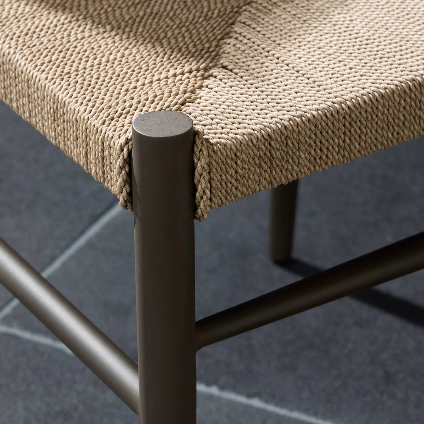 005 SI-2327576 | Closeup | Lomas Outdoor Metal Dining Chair by Four Hands in textured dune, bronze. Made from 100% polyethylene, iron in a unique style.