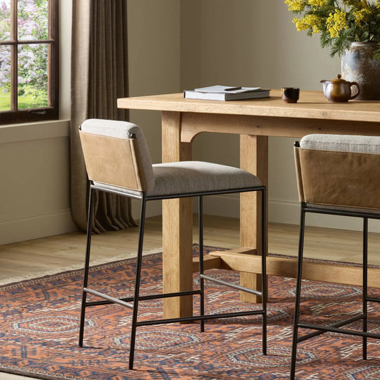 Elba Counter Stool by Four Hands in alcala wheat, dark gris gunmetal, palermo drift. Made from 70% polyester, 20% viscose (rayon), 10% flax/linen, iron, top grain leather in a transitional style.
