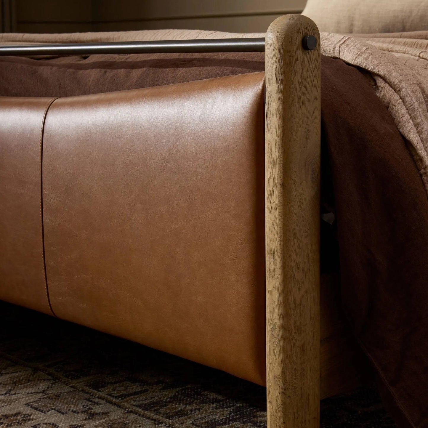 011 SI-2446539 | Closeup | Dina Bed by Four Hands in sonoma chestnut, aged smoked oak, aged smoked oak veneer. Made from top grain leather, solid oak, thick oak veneer in a transitional style.