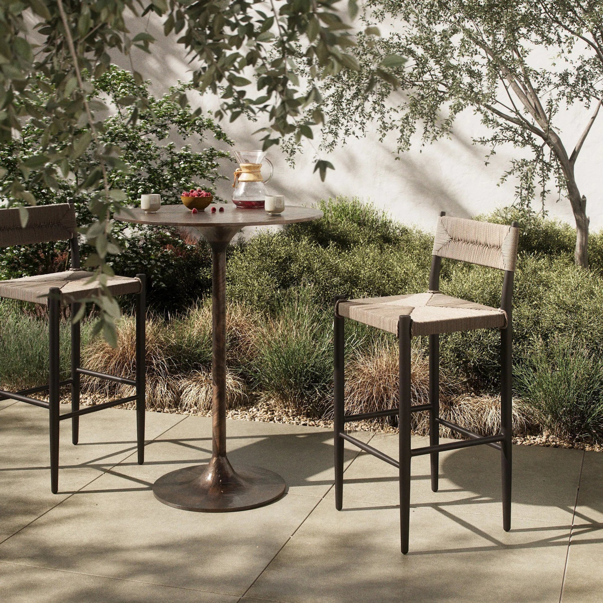 Lomas Outdoor Bar Stool by Four Hands in textured dune, bronze. Made from 100% polyethylene, iron in a unique style.
