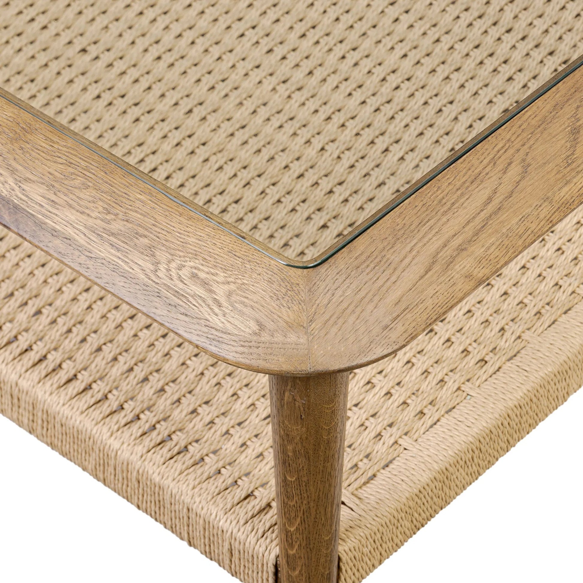 Carmelo Coffee Table by Four Hands in tempered glass, natural paper cord, medium brown oak. Made from tempered glass, rush, solid oak in a transitional style.