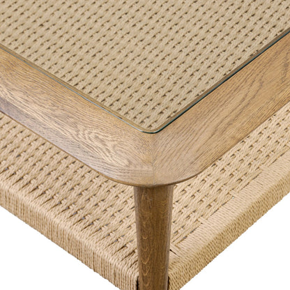 Carmelo Coffee Table by Four Hands in tempered glass, natural paper cord, medium brown oak. Made from tempered glass, rush, solid oak in a transitional style.