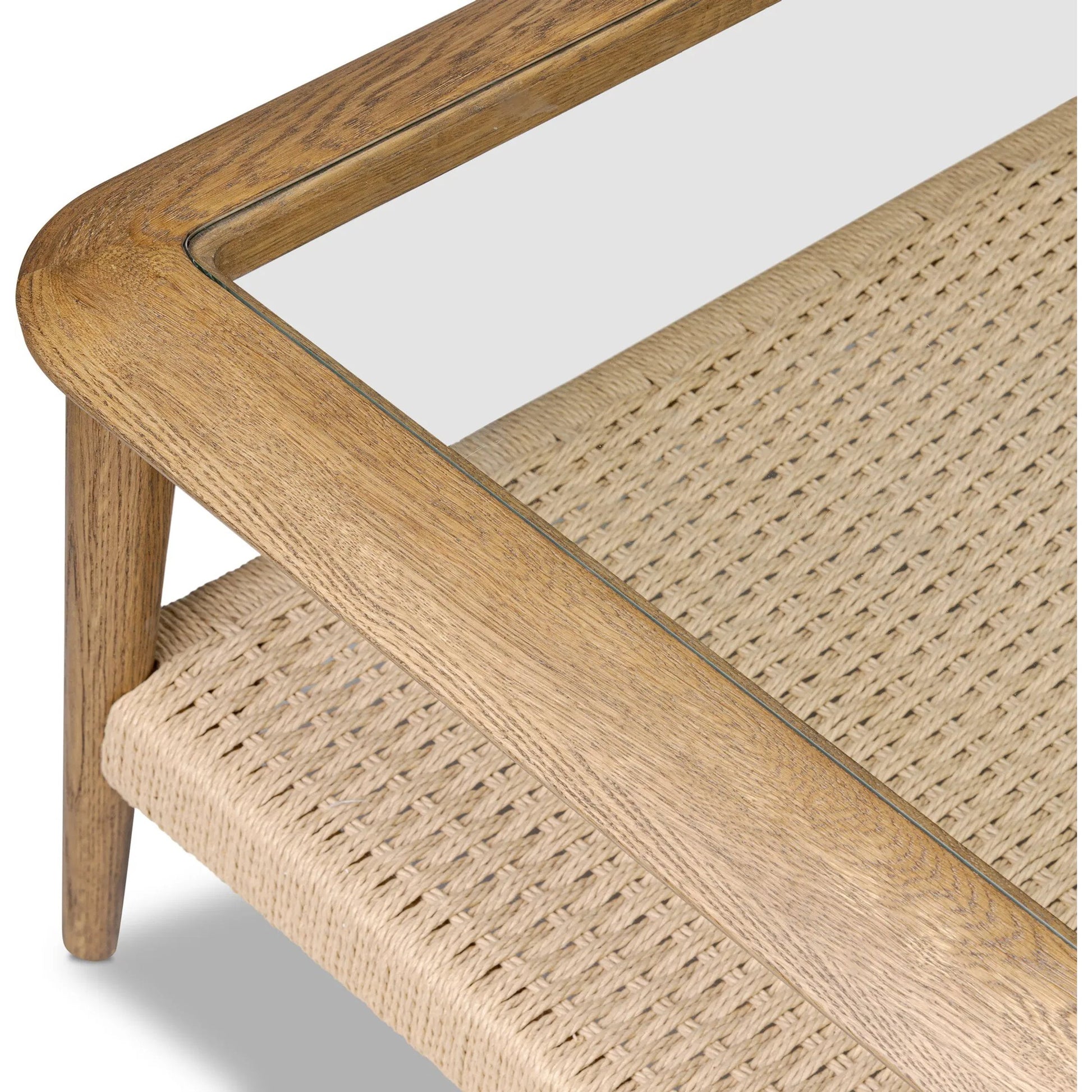 Carmelo Coffee Table by Four Hands in tempered glass, natural paper cord, medium brown oak. Made from tempered glass, rush, solid oak in a transitional style.