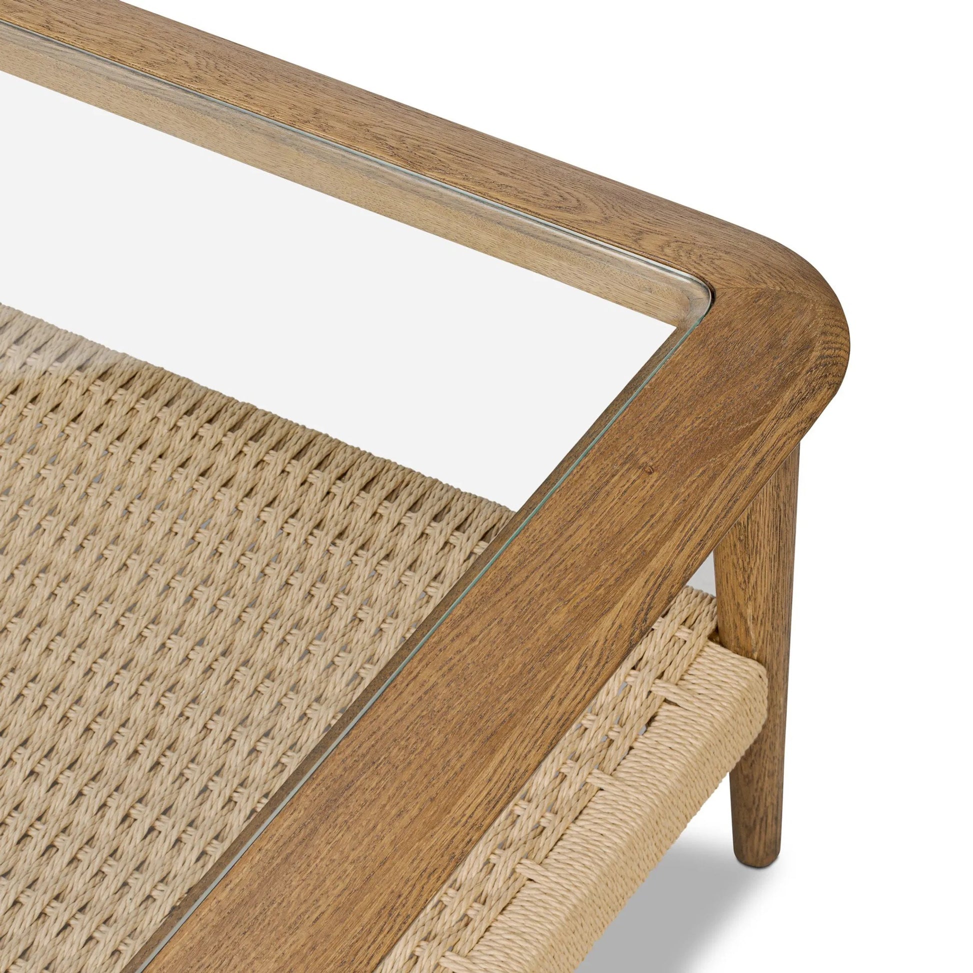 Carmelo Coffee Table by Four Hands in tempered glass, natural paper cord, medium brown oak. Made from tempered glass, rush, solid oak in a transitional style.