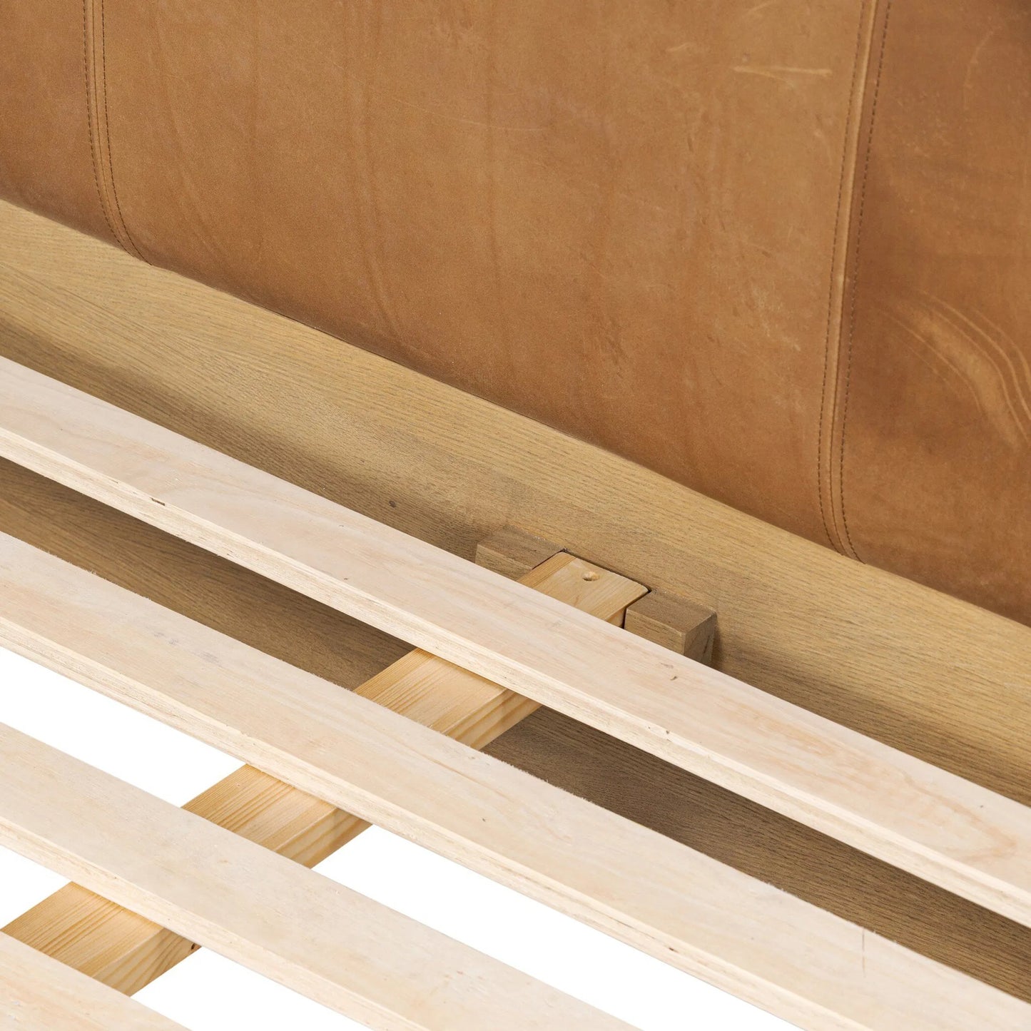 010 SI-2446644,SI-2446645 | Closeup | Rane Bed by Four Hands in heirloom sienna, honey brown oak veneer, honey brown oak. Made from top grain leather, thick oak veneer, solid oak in a transitional style.