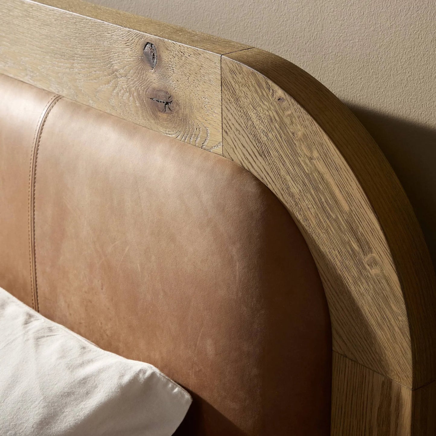 006 SI-2446644,SI-2446645 | Closeup | Rane Bed by Four Hands in heirloom sienna, honey brown oak veneer, honey brown oak. Made from top grain leather, thick oak veneer, solid oak in a transitional style.