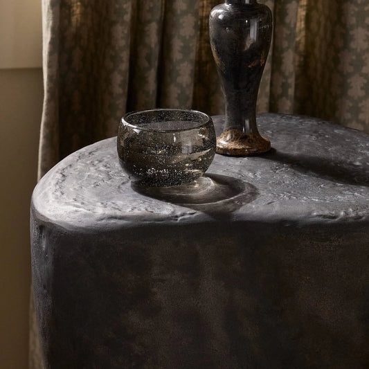 Bomba Small End Table by Four Hands in textured black concrete. Made from solid concrete in a transitional style.