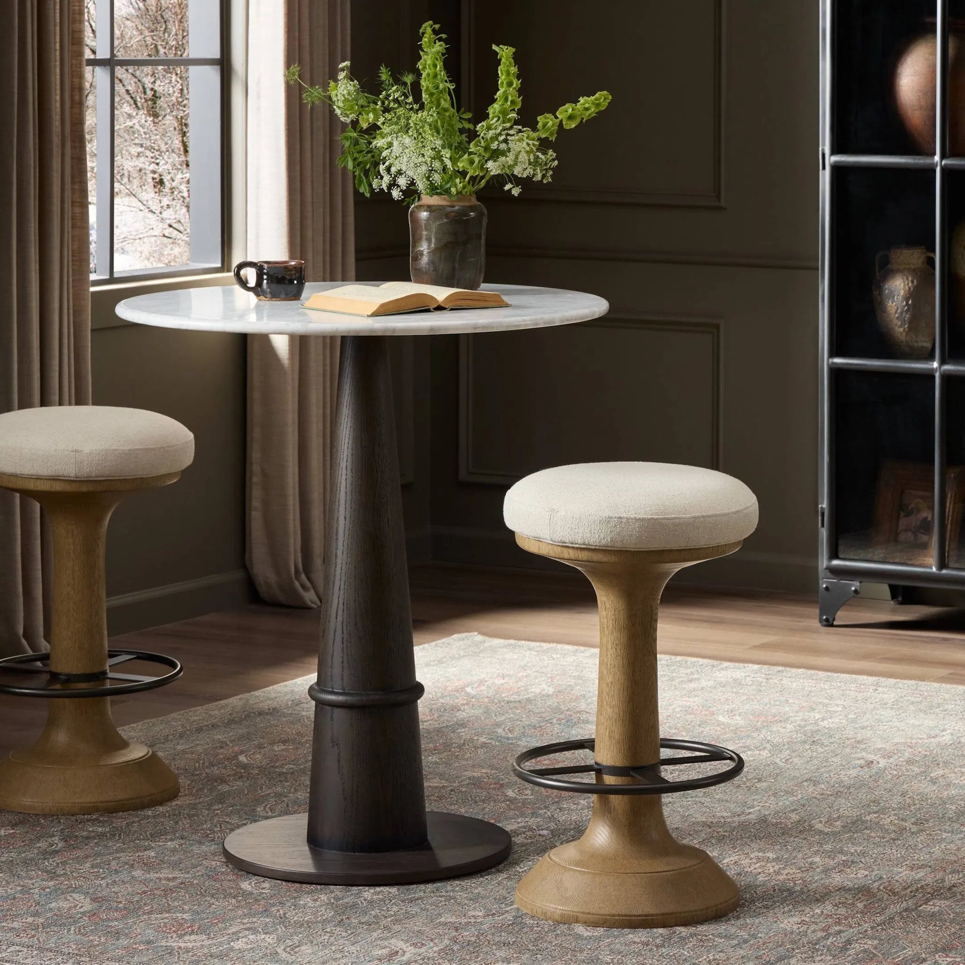Montclair Stool by Four Hands in antwerp natural, drifted oak resin, aged iron. Made from 39% flax/linen, 35% cotton, 26% polyester, composite resin mixture, iron in a unique style.
