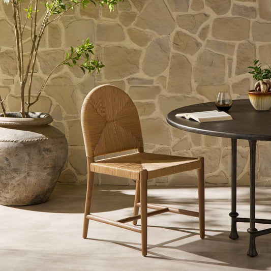 Abilene Outdoor Dining Chair by Four Hands in fine textured natural, stained toasted brown. Made from 100% polyethylene, solid teak in a rustic style.