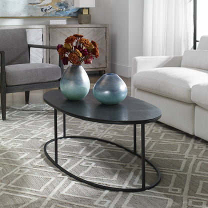 Coreene Oval Coffee Table by Uttermost in antique black. Made from iron, aluminum in a transitional style.