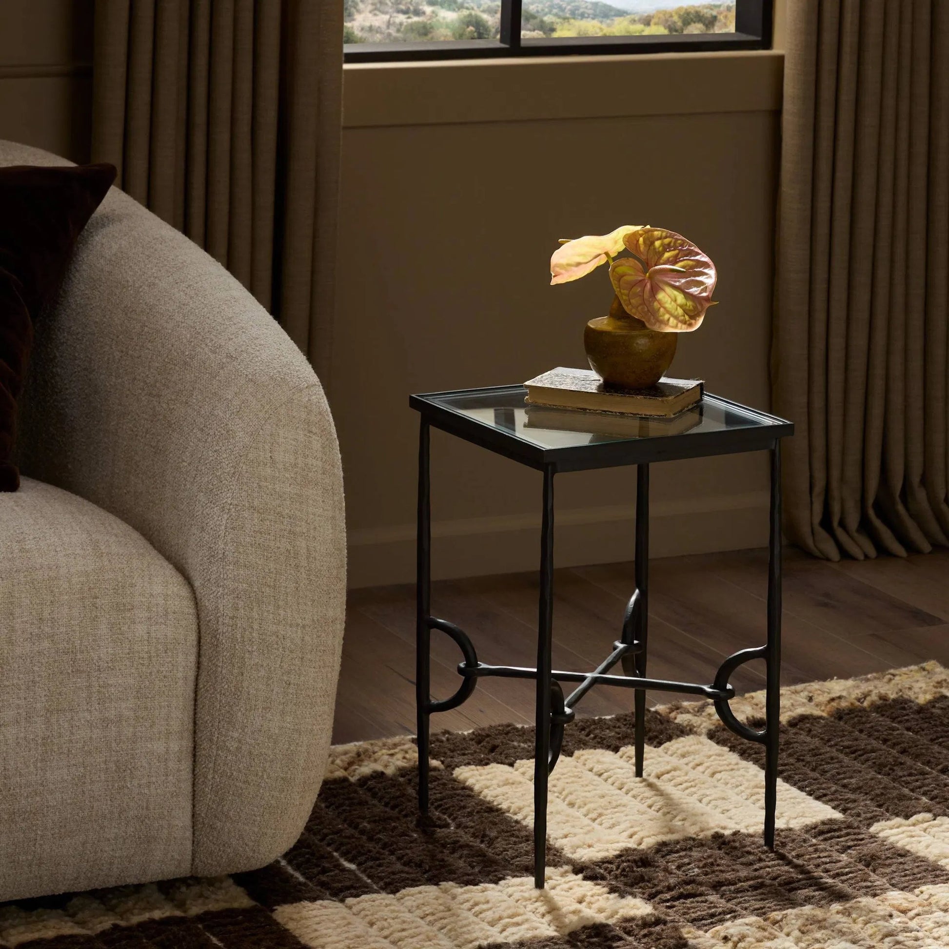 Babylon Small End Table by Four Hands in tempered glass, hammered gunmetal. Made from tempered glass, iron in a modern style.
