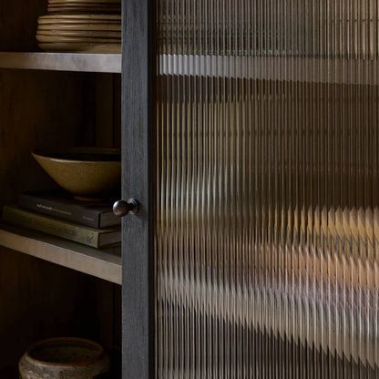 Leopold Cabinet by Four Hands in black hemlock, tempered glass, sandy hemlock. Made from hemlock solid, tempered glass in a unique style.