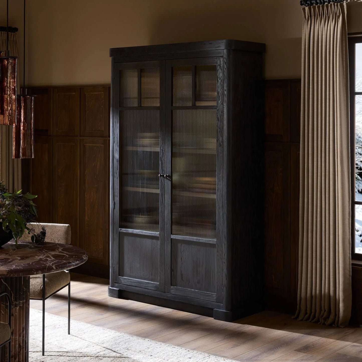 012 SI-2531655 | Lifestyle | Leopold Cabinet by Four Hands in black hemlock, tempered glass, sandy hemlock. Made from hemlock solid, tempered glass in a unique style.