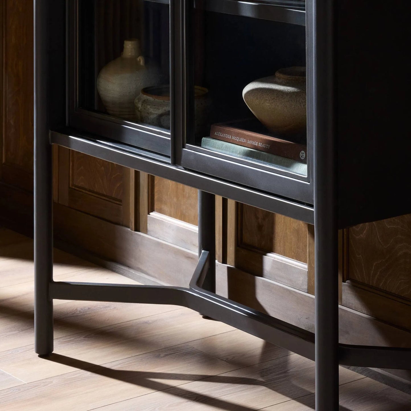 012 SI-2531699 | Closeup | Saxon Cabinet by Four Hands in brushed bronze patina, tempered glass. Made from iron, tempered glass in a unique style.