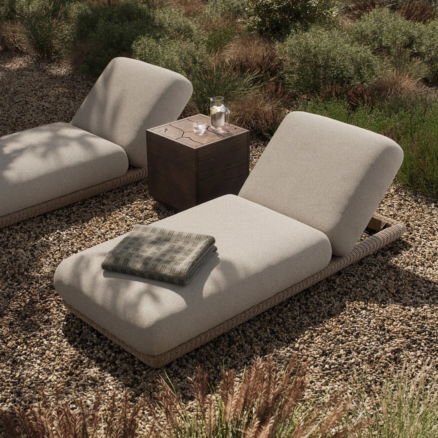 012 SI-2531618 | Lifestyle | Evander Outdoor Chaise by Four Hands in ramiro ecru, vintage white. Made from 100% polypropylene, 100% polyethylene in a transitional style.