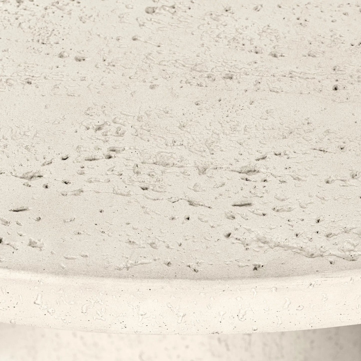007 SI-2531728 | Closeup | Varda Outdoor Dining Table by Four Hands in coarse ivory concrete. Made from solid concrete in a unique style.