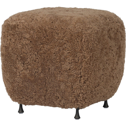 Joey Ottoman by Four Hands in amber shearling, hammered black. Made from shearling, iron in a unique style.