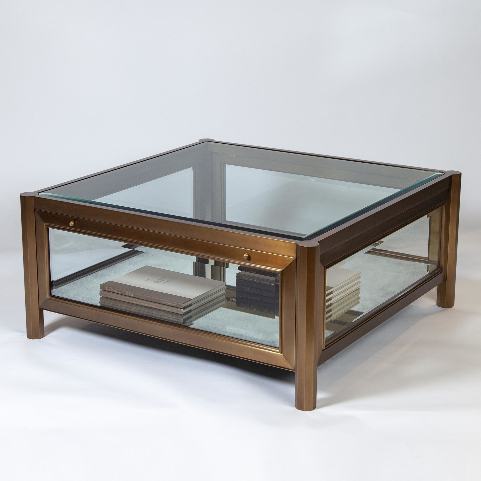 Apothecary Cocktail Table by Global Views in dark brass. Made from poplar, beveled glass in a transitional style.