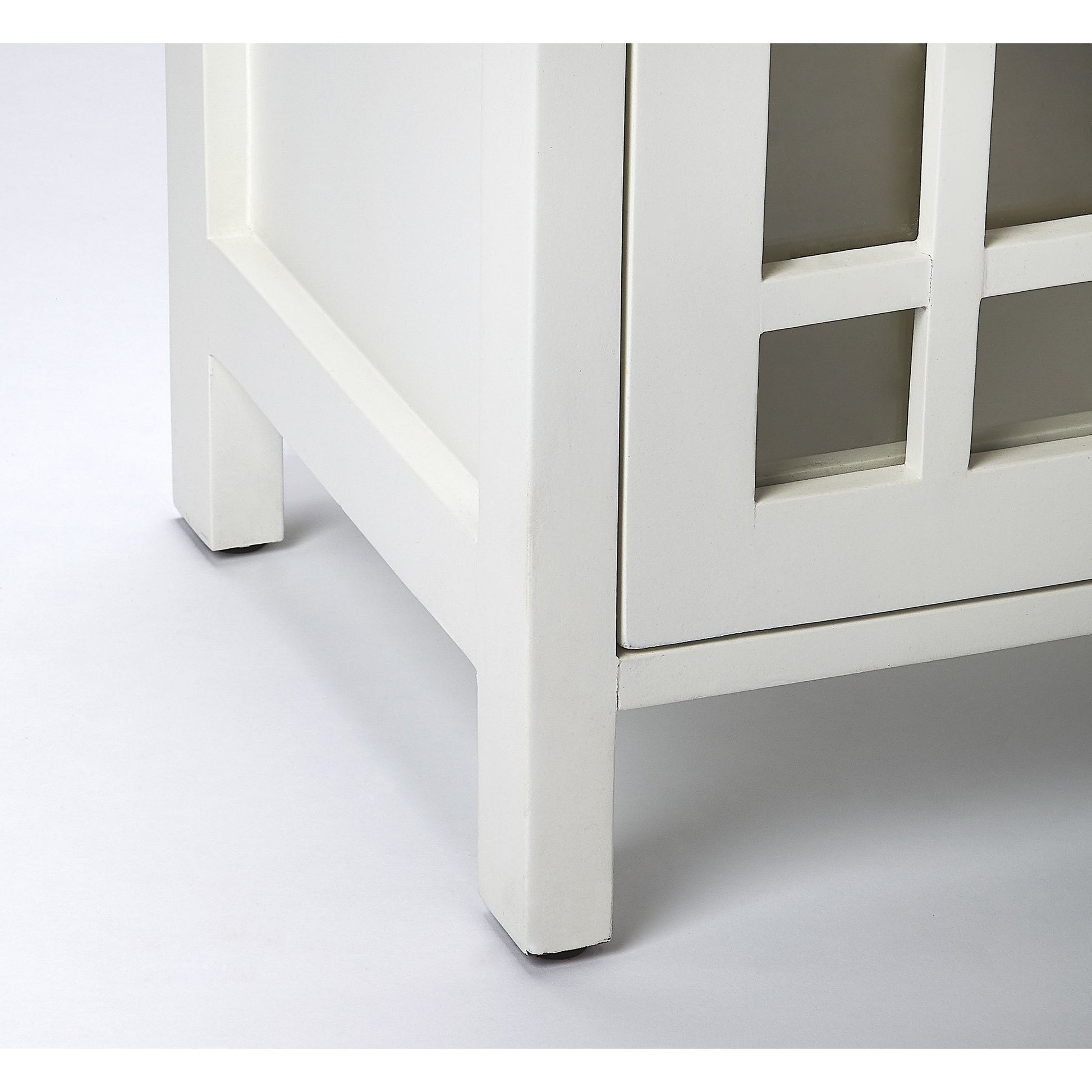 Baxter Chairside Chest by Butler Specialty Company in white and glossy white. Made from mango wood solids, mdf, clear glass, iron, antique finish in a cottage & farmhouse style.