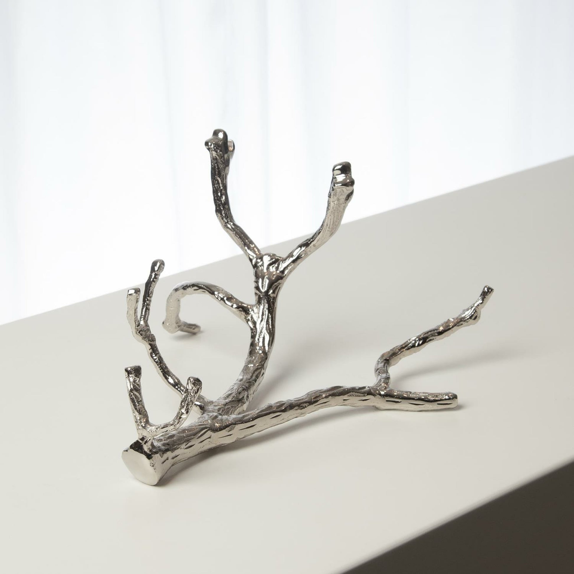 Twig Wine Bottle Holder by Global Views. Made from cast brass in a eclectic & global style.