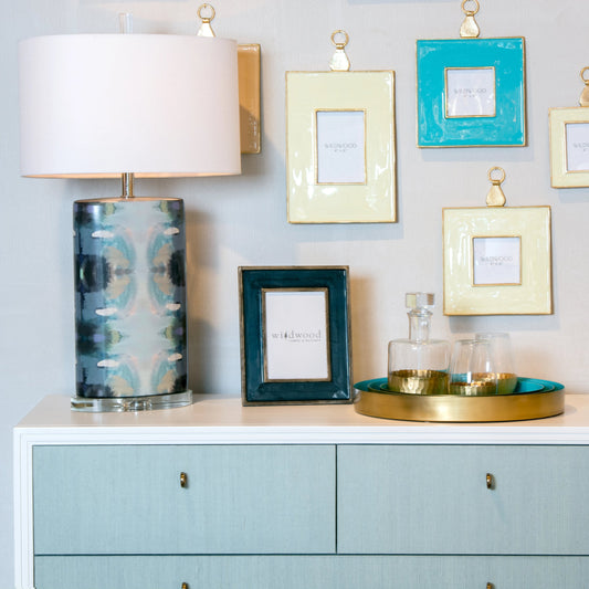 Teal Frame by Wildwood in teal, antique gold enamel, clear. Made from aluminum, glass in a transitional style.