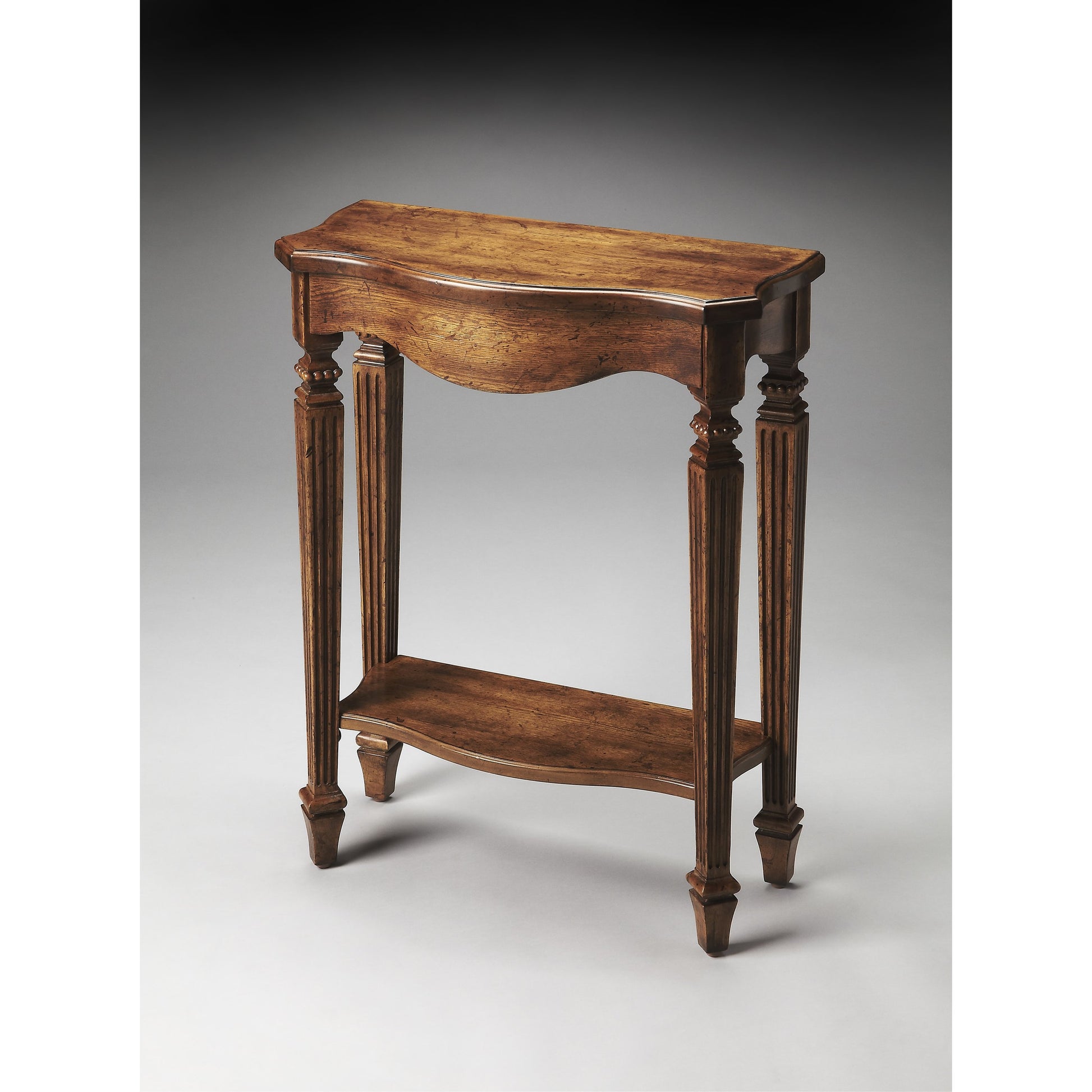 Cheshire Console Table by Butler Specialty Company. Made from poplar, resin, cherry veneer and fiberboard in a traditional style.