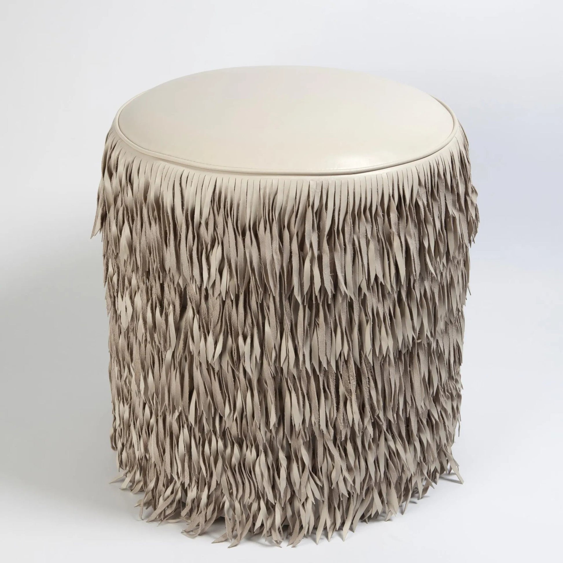 Fringe Ottoman by Global Views. Made from mdf, leather, pvc in a unique style.