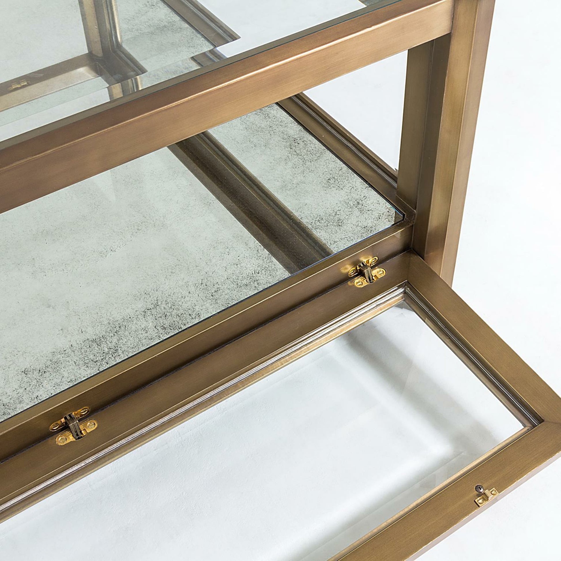 Apothecary Cocktail Table by Global Views in dark brass. Made from poplar, beveled glass in a transitional style.