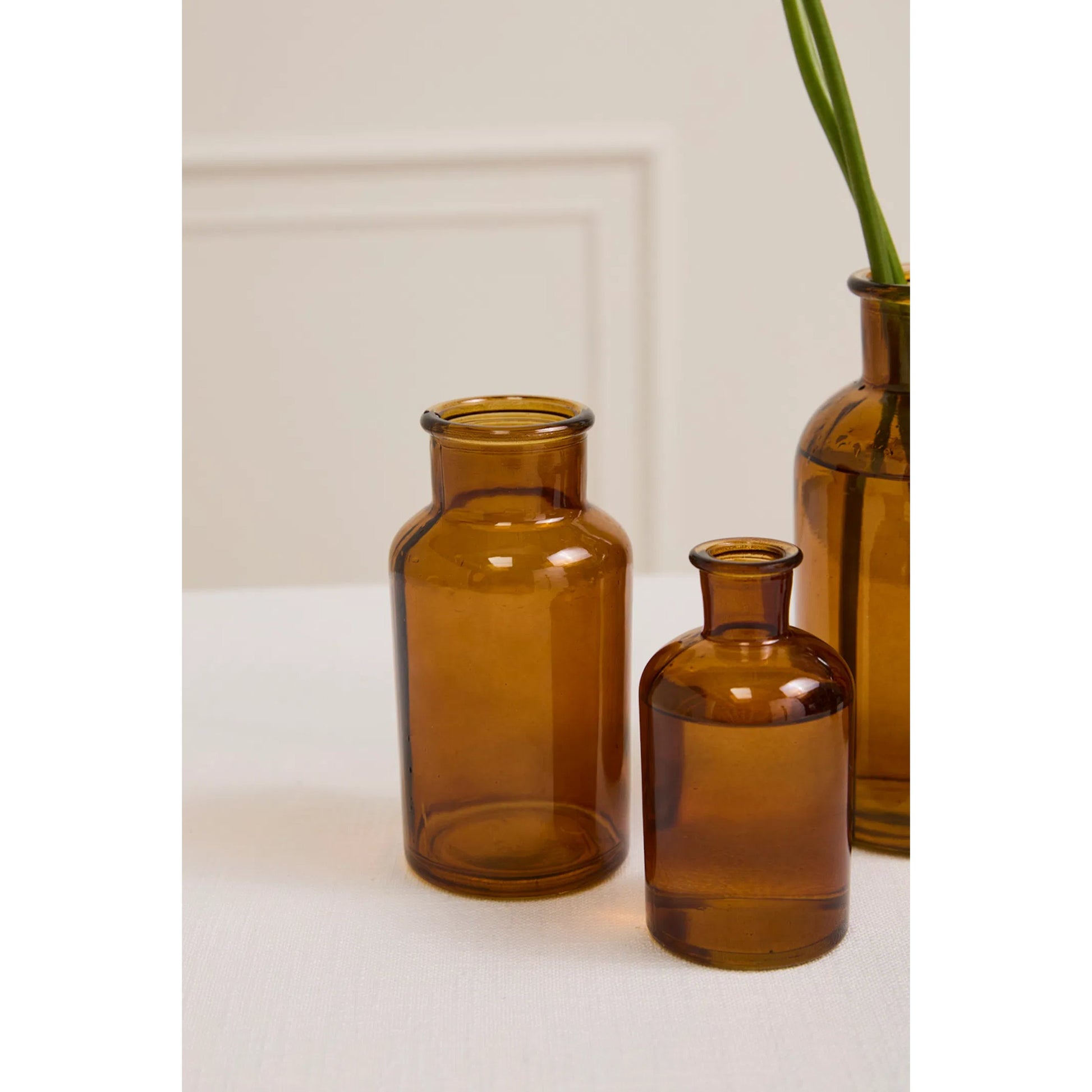 Amber Billie Bottle by Accent Decor in amber. Made from glass in a unique style.